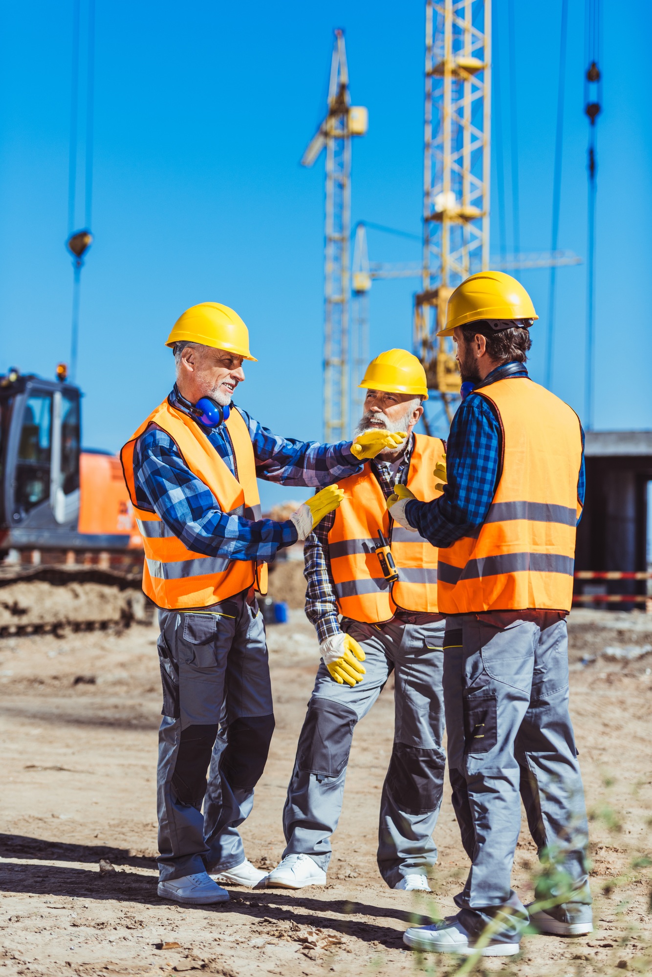 Foreman explaining builders work process by gesturing at the construction site